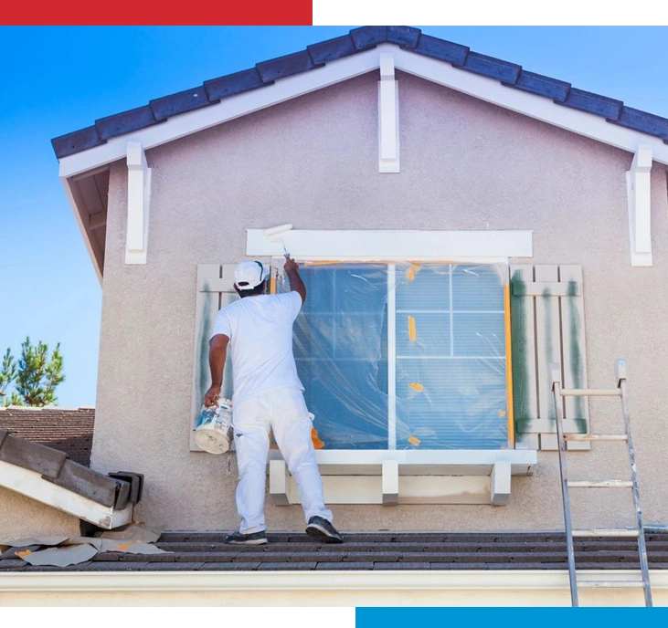 A man painting the outside of a house.